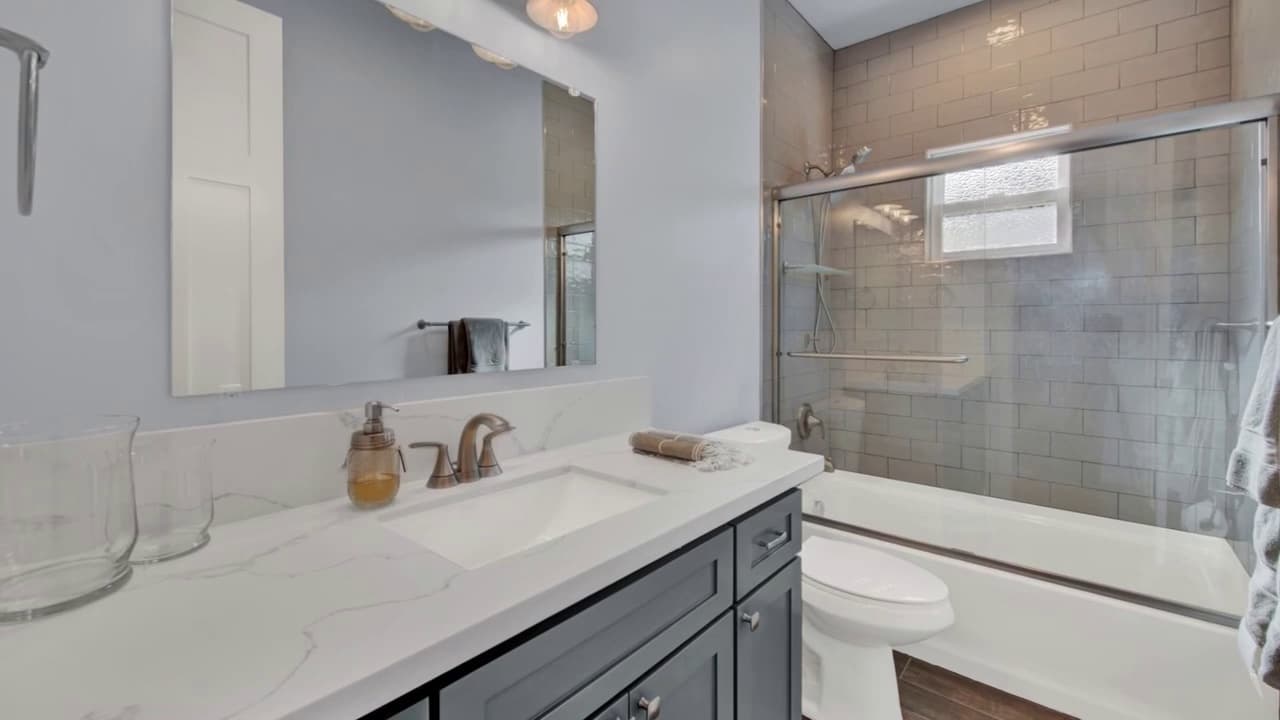Guest bathroom remodel with tub/shower combo and custom tile surround in Sacramento — Keystone Building Services